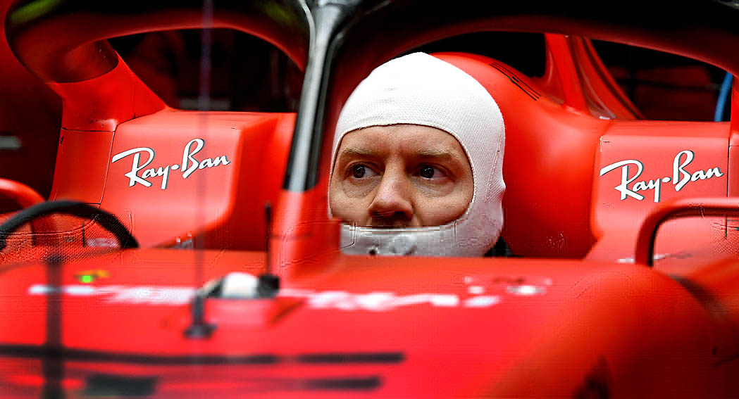 Vettel sits in a Ferrari, looking pensive, dailycarblog F1 news